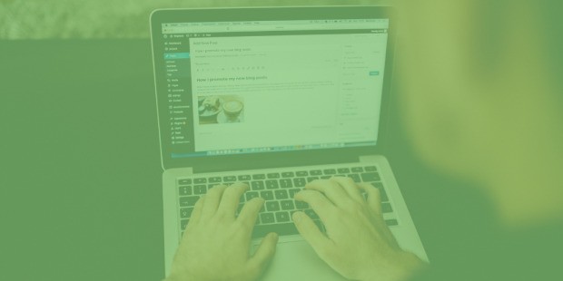 Hands typing on laptop with WordPress blog draft showing on screen